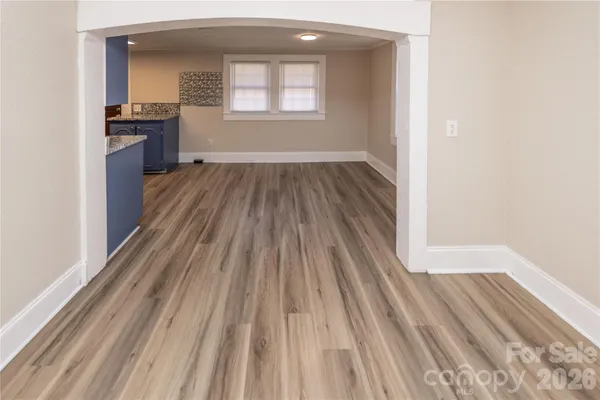 a view of a room with wooden floor a fireplace