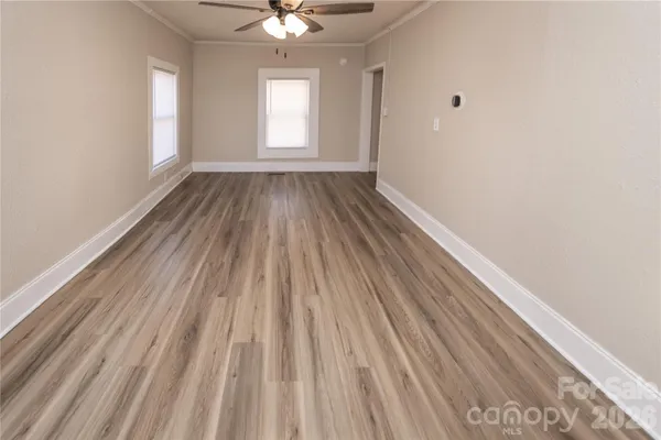 wooden floor in an empty room with a window