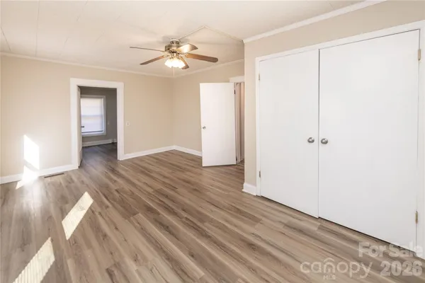 an empty room with wooden floor and closet