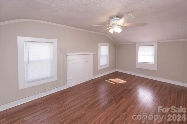 a view of wooden floor and windows in an empty room
