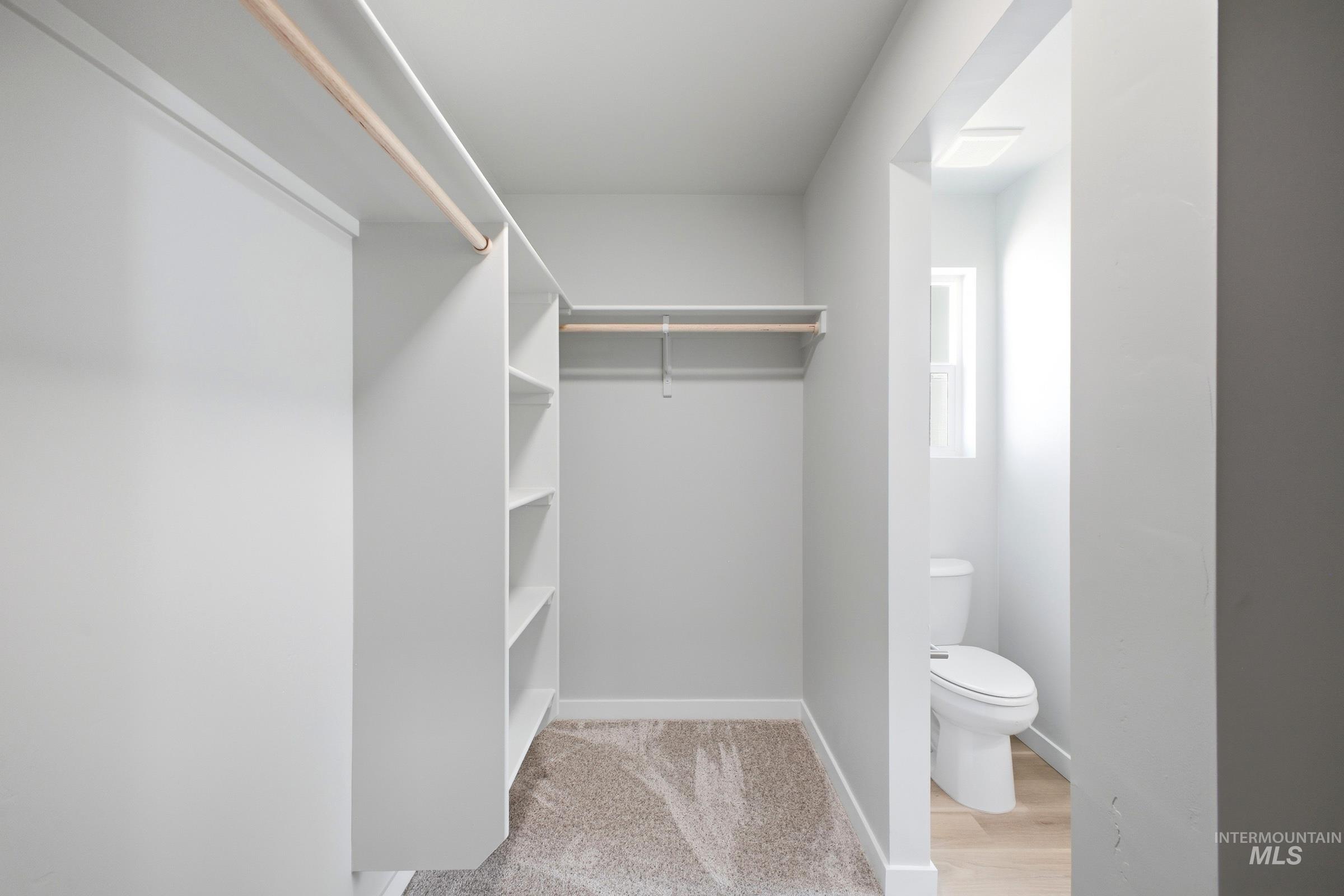 16434 Backfill Avenue Caldwell, ID 83607 - Photo 19 of 19 Walk-in closet featuring built-in shelving, hanging rods, and carpeted flooring