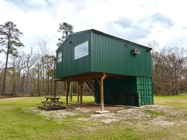 a backyard of a house with lots of green space and trees