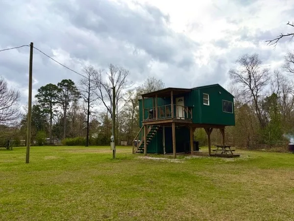 a backyard of a house with table and chairs