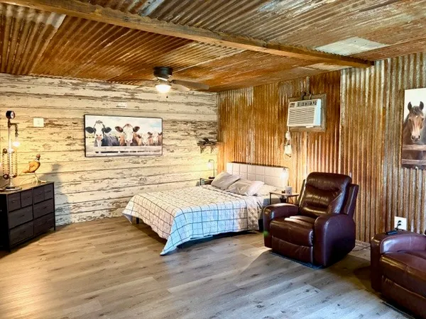 a living room with furniture and wooden floor