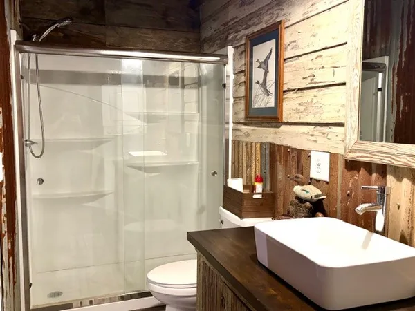 a bathroom with a sink toilet and shower