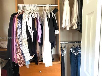 8601 Southwest 94th Street, Unit 227W Miami, FL 33156 - Photo 13 of 17 a view of walk in closet with clothes and shoes