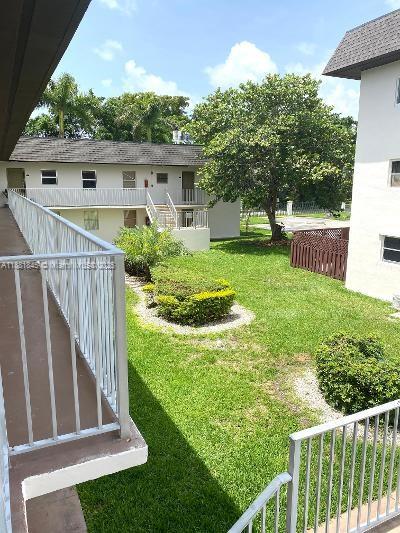 8601 Southwest 94th Street, Unit 227W Miami, FL 33156 - Photo 14 of 17 a view of a house with backyard and a tree