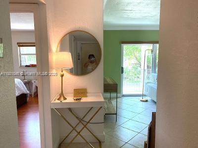 8601 Southwest 94th Street, Unit 227W Miami, FL 33156 - Photo 2 of 17 a living room with couches a flat tv screen and a dining table with garden view