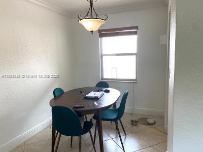 8601 Southwest 94th Street, Unit 227W Miami, FL 33156 - Photo 8 of 17 a view of a dining room with furniture window and wooden floor