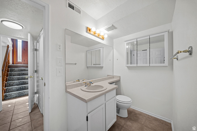 11934 South Cedar Ridge Road Sandy, UT 84094 - Photo 35 of 58 Vanity with integrated sink, wall-mounted tri-view medicine cabinet, and tile flooring