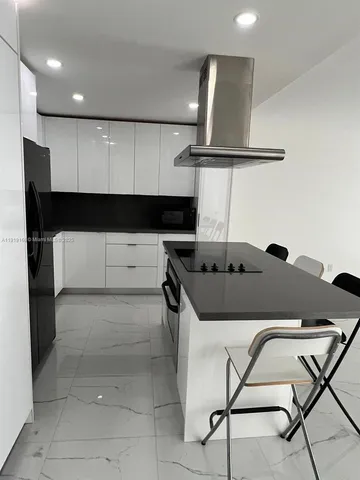 a kitchen with a table and chairs