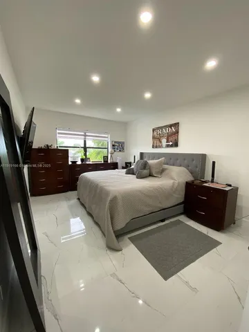 a bedroom with a large bed and a couch