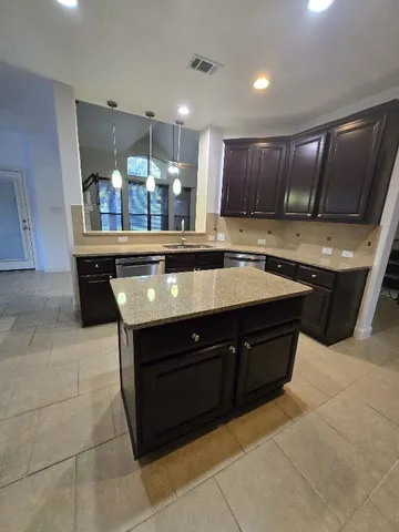 a kitchen with a sink and cabinets