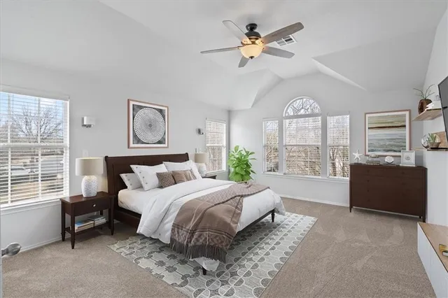 a spacious bedroom with a large bed and a large window