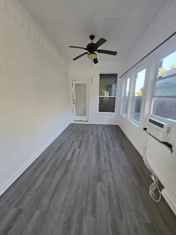 wooden floor in an empty room with a window