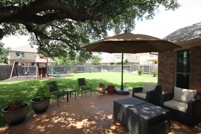 a view of a patio with furniture and a yard