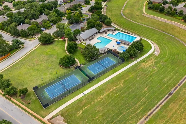 an aerial view of a residential houses with outdoor space