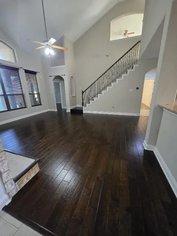 a view of entryway and hall with wooden floor
