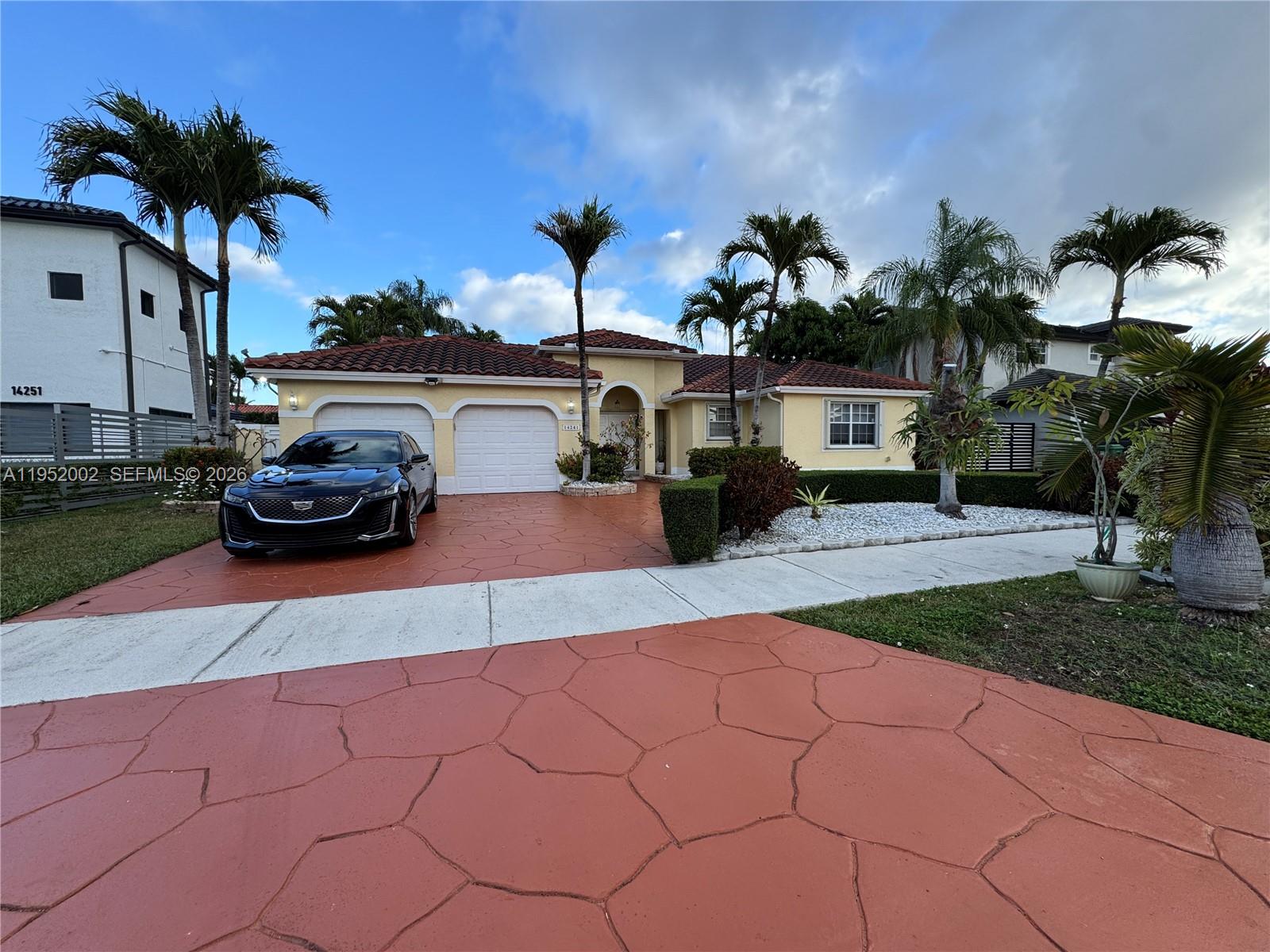 14241 Southwest 36th Street Miami, FL 33175 - Photo 1 of 18 a front view of a house with a yard and a garage