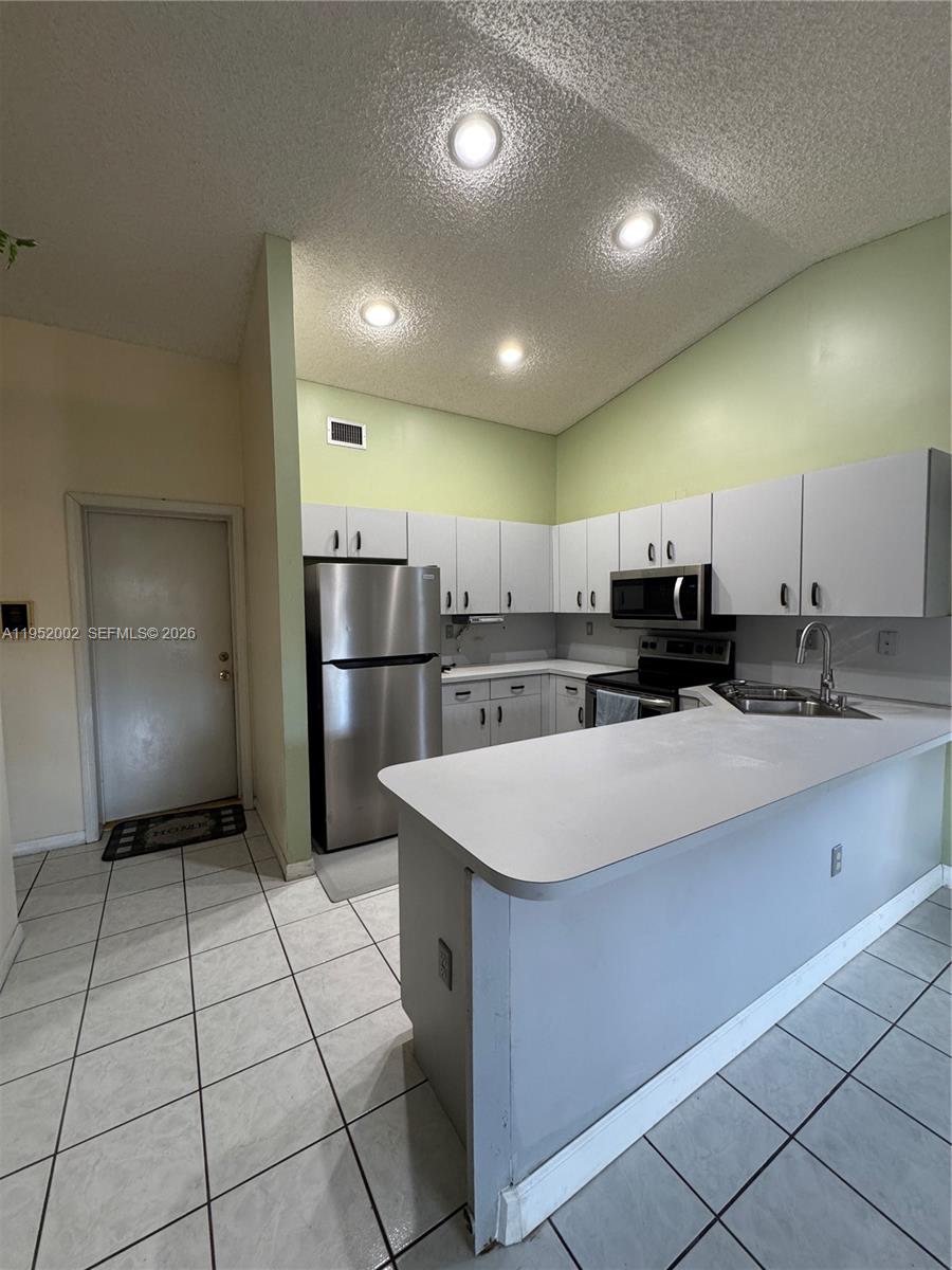 14241 Southwest 36th Street Miami, FL 33175 - Photo 4 of 18 a large kitchen with a large counter top stainless steel appliances and cabinets