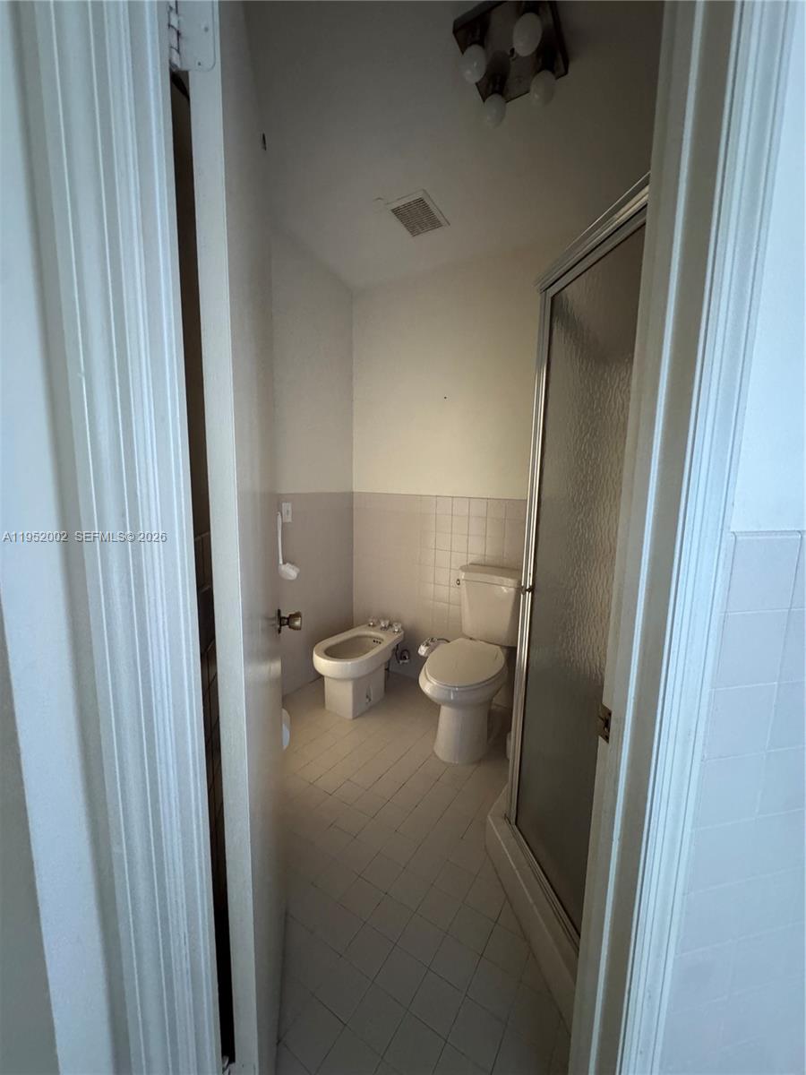 14241 Southwest 36th Street Miami, FL 33175 - Photo 9 of 18 a bathroom with a toilet and a shower