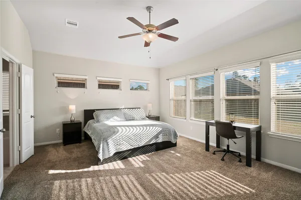 a bedroom with a bed and a large window