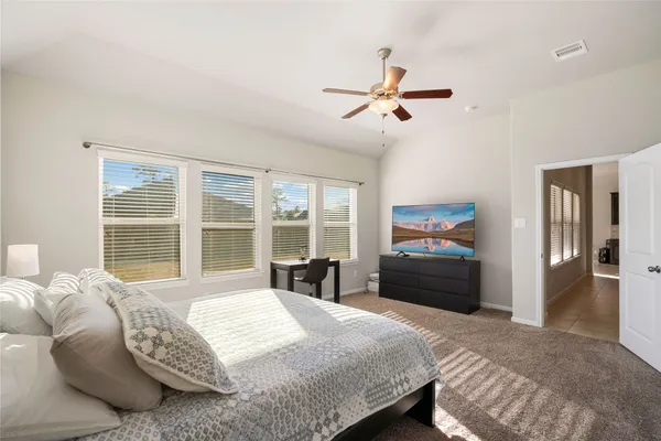 a bedroom with a bed and a large window