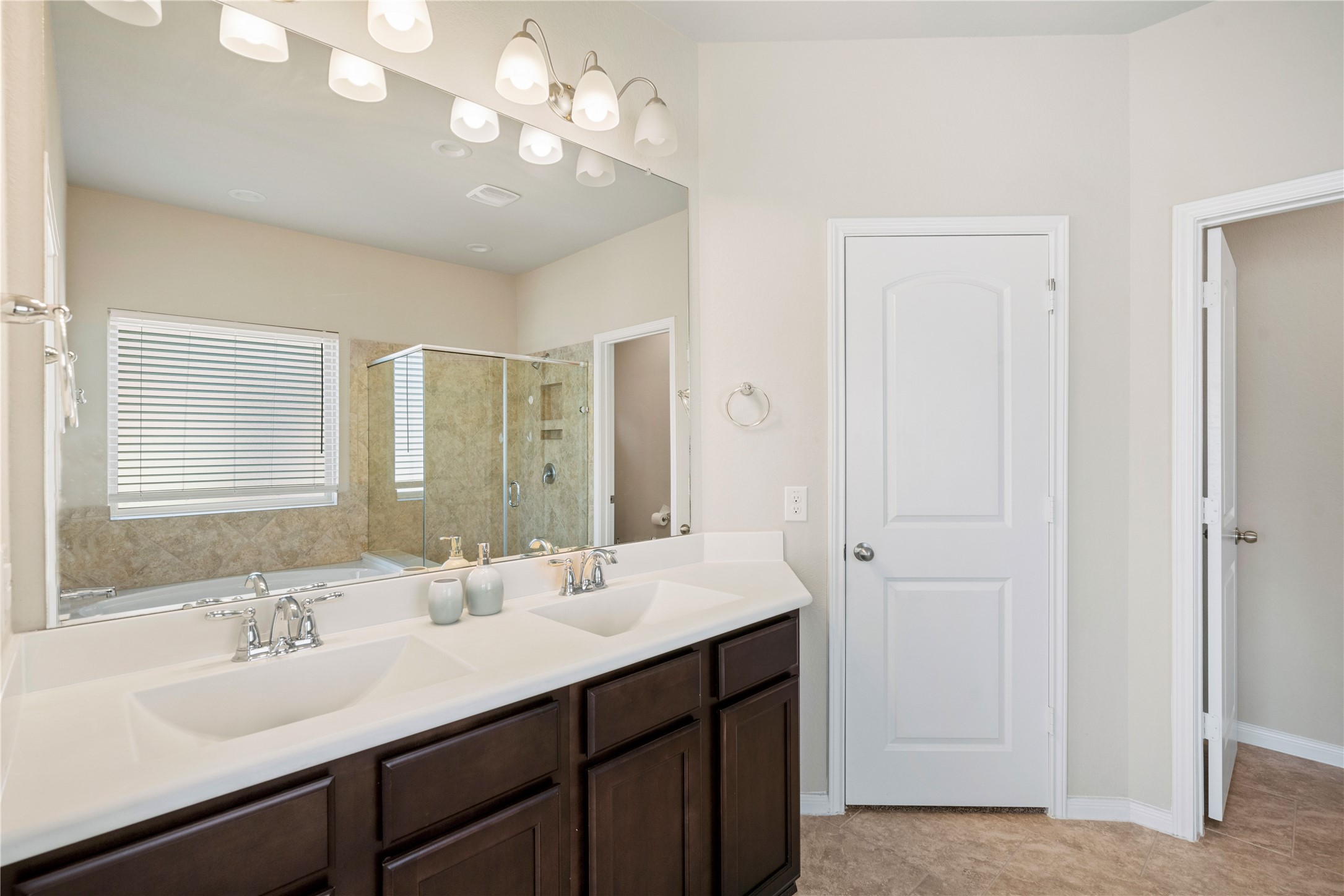 14300 Congaree Court Conroe, TX 77384 - Photo 19 of 31 a bathroom with a sink double vanity and a mirror