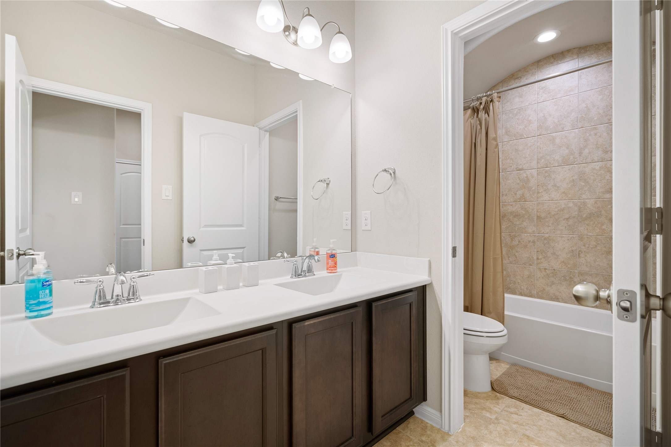 14300 Congaree Court Conroe, TX 77384 - Photo 22 of 31 a bathroom with a double vanity sink mirror and toilet