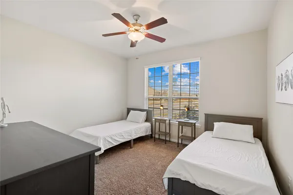 a bedroom with a bed and a desk