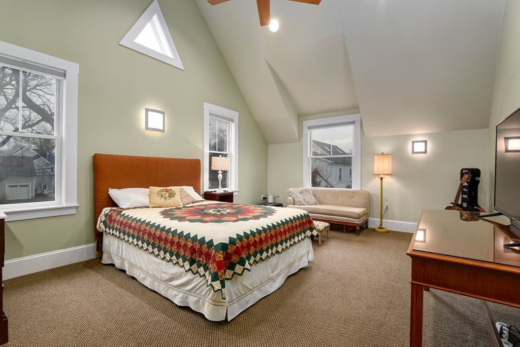 159 Warren Street Needham, MA 02492 - Photo 16 of 42 a bedroom with a bed and a table chair