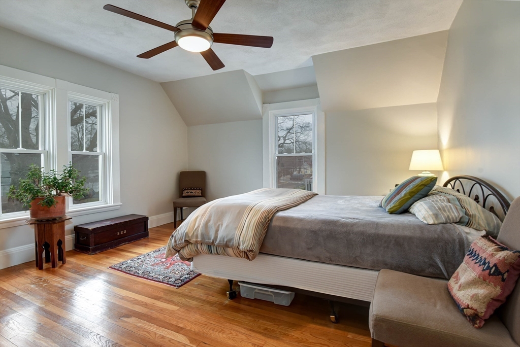 159 Warren Street Needham, MA 02492 - Photo 18 of 42 a bedroom with a bed and wooden floor