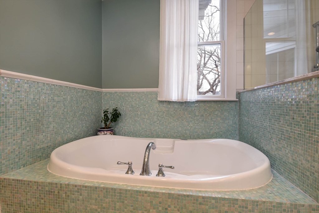159 Warren Street Needham, MA 02492 - Photo 24 of 42 a white bath tub sitting in a bathroom next to a window