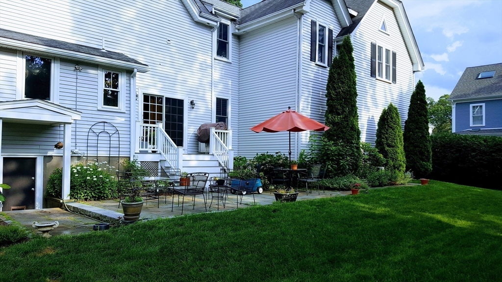 159 Warren Street Needham, MA 02492 - Photo 28 of 42 a backyard of a house with table and chairs