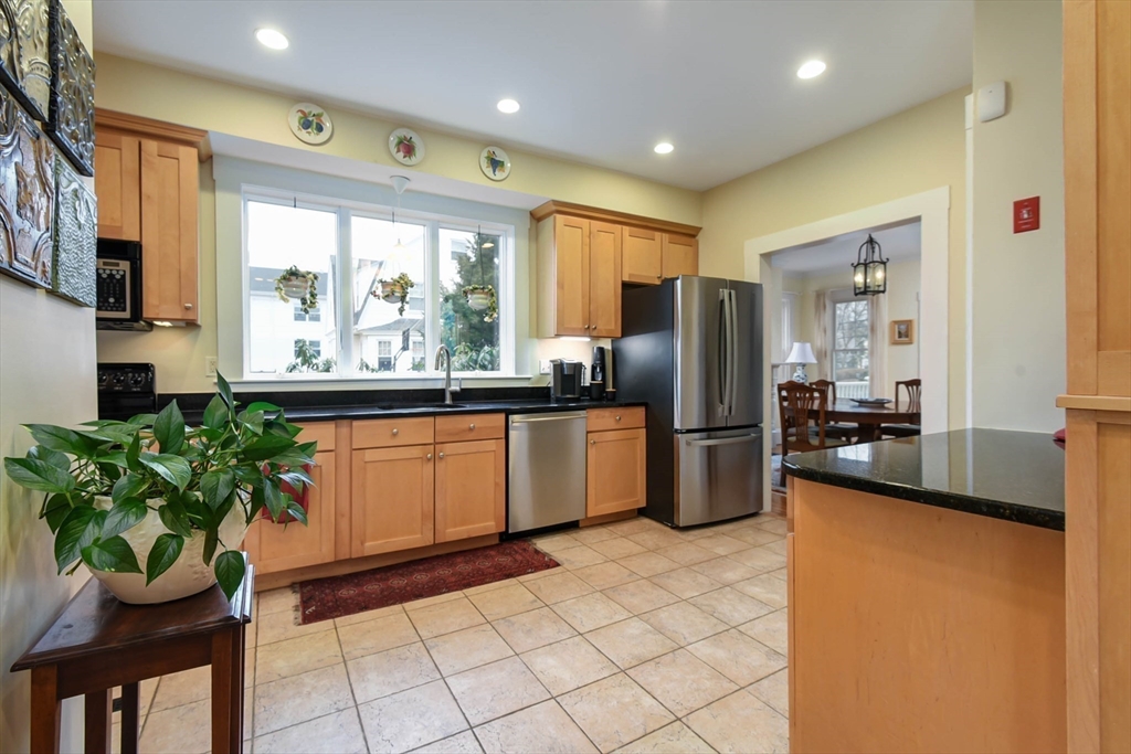 159 Warren Street Needham, MA 02492 - Photo 5 of 42 a kitchen with a sink stainless steel appliances and cabinets