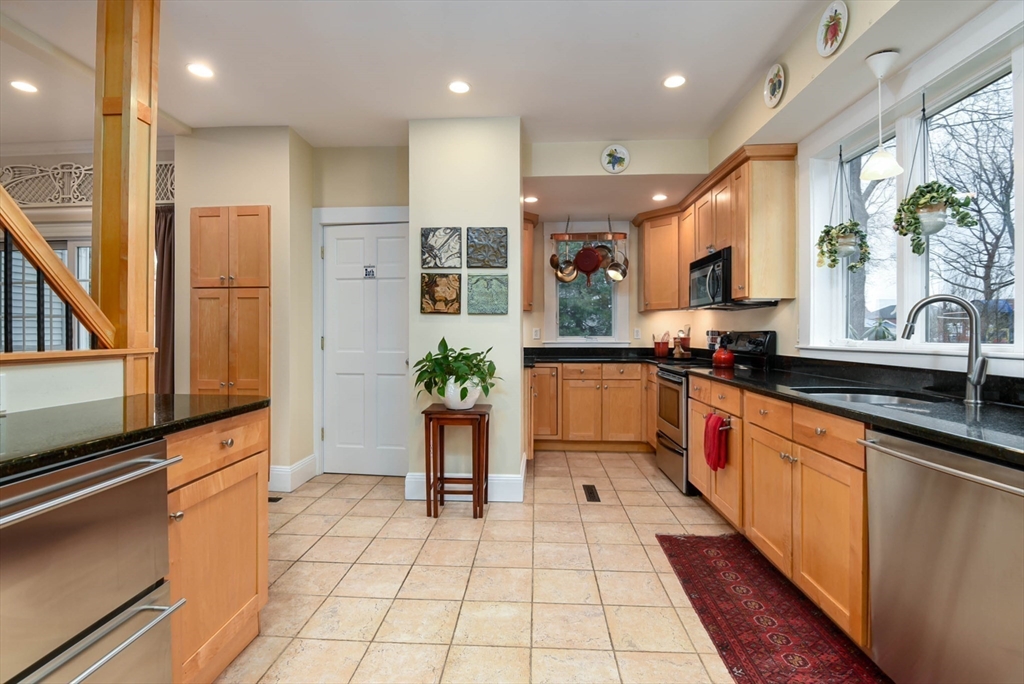159 Warren Street Needham, MA 02492 - Photo 6 of 42 a large kitchen with stainless steel appliances kitchen island granite countertop a sink and cabinets