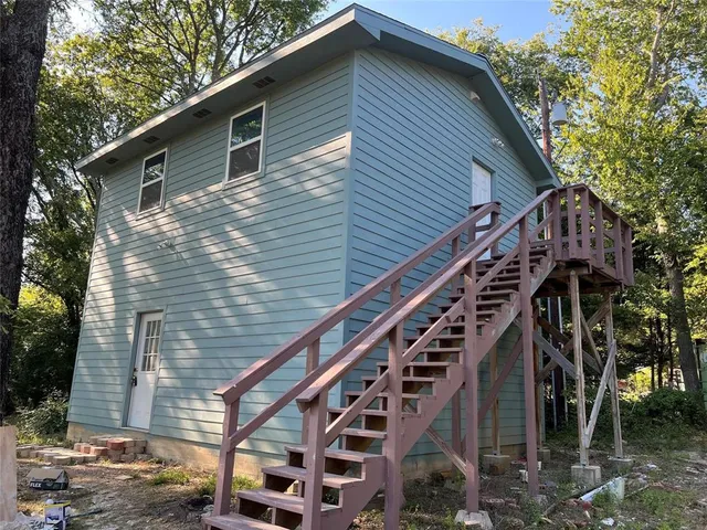 a front view of a house with stairs