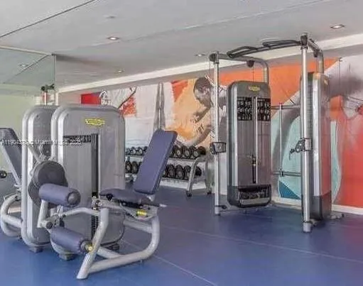 a room with gym equipment and mirror