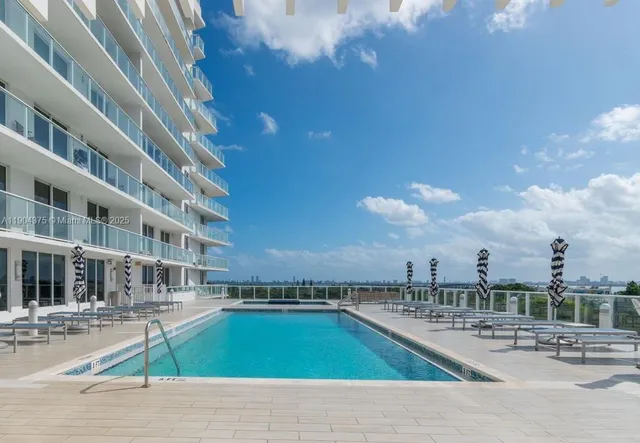 a view of a swimming pool with a lounge chairs