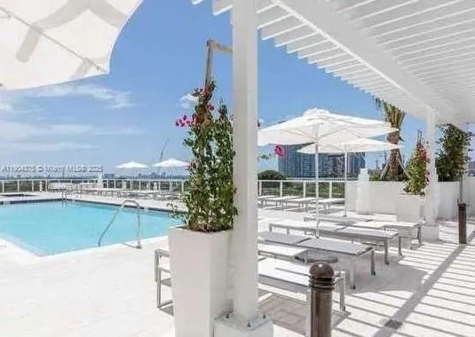 a view of a house with swimming pool and sitting area