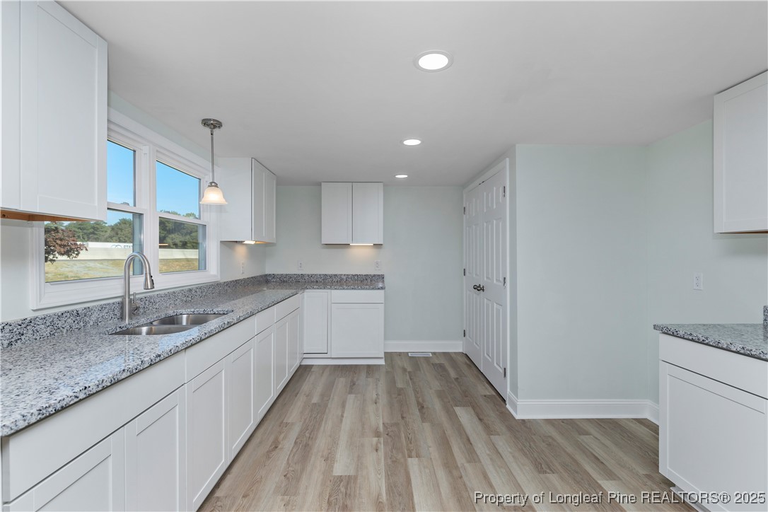 1340 George Perry Lee Road Dunn, NC 28334 - Photo 20 of 31 a large kitchen with a sink and wooden floor