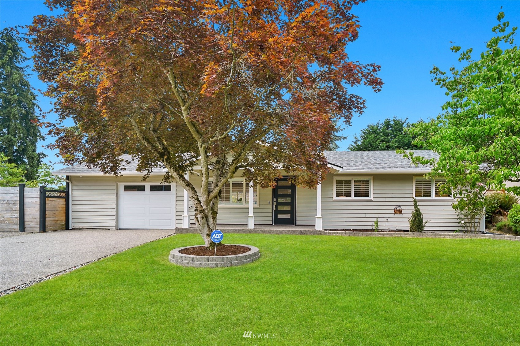 a front view of house with yard and green space