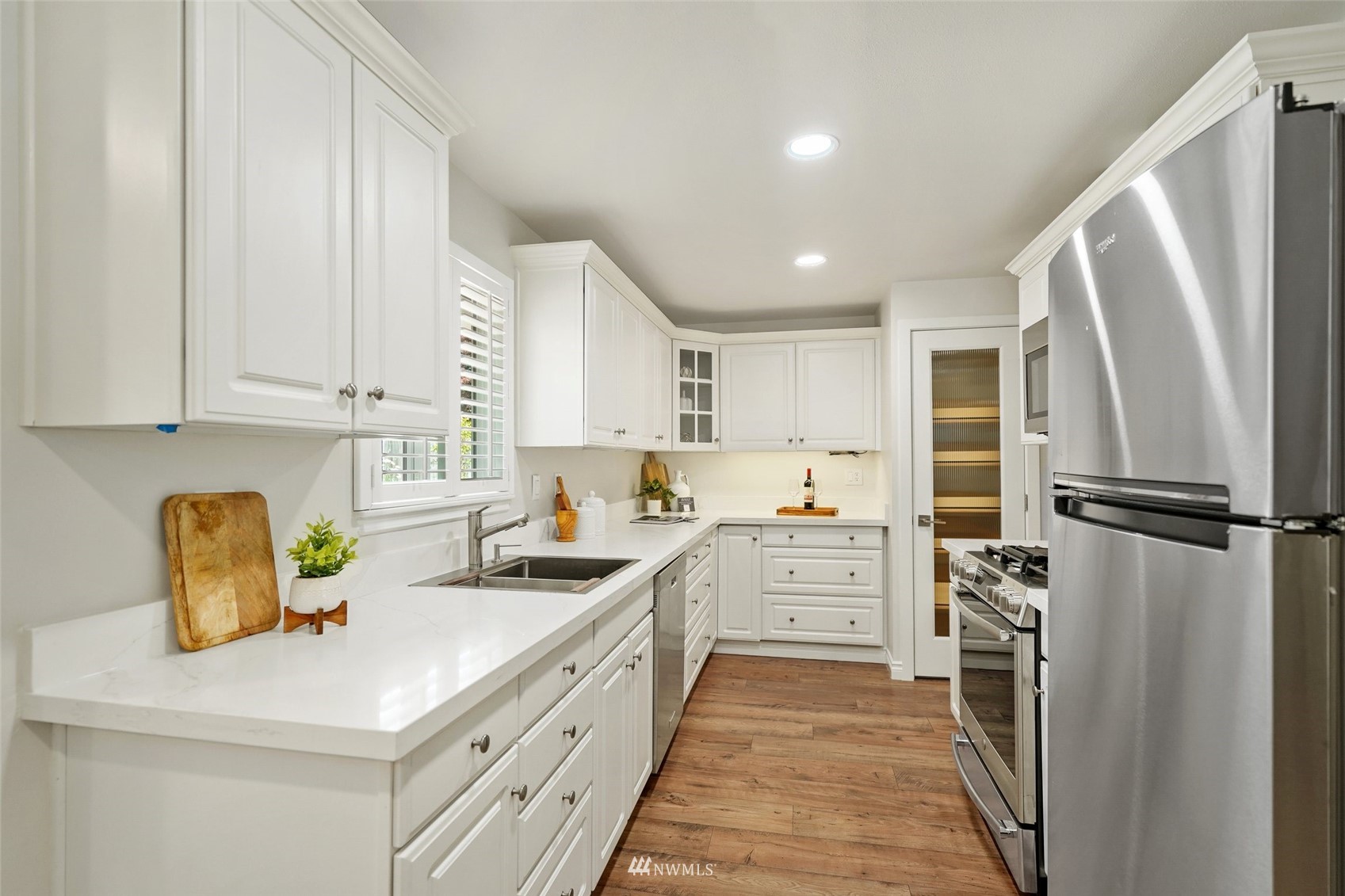 3007 Stafford Way Bothell, WA 98012 - Photo 13 of 32 a kitchen with a sink a refrigerator and cabinets