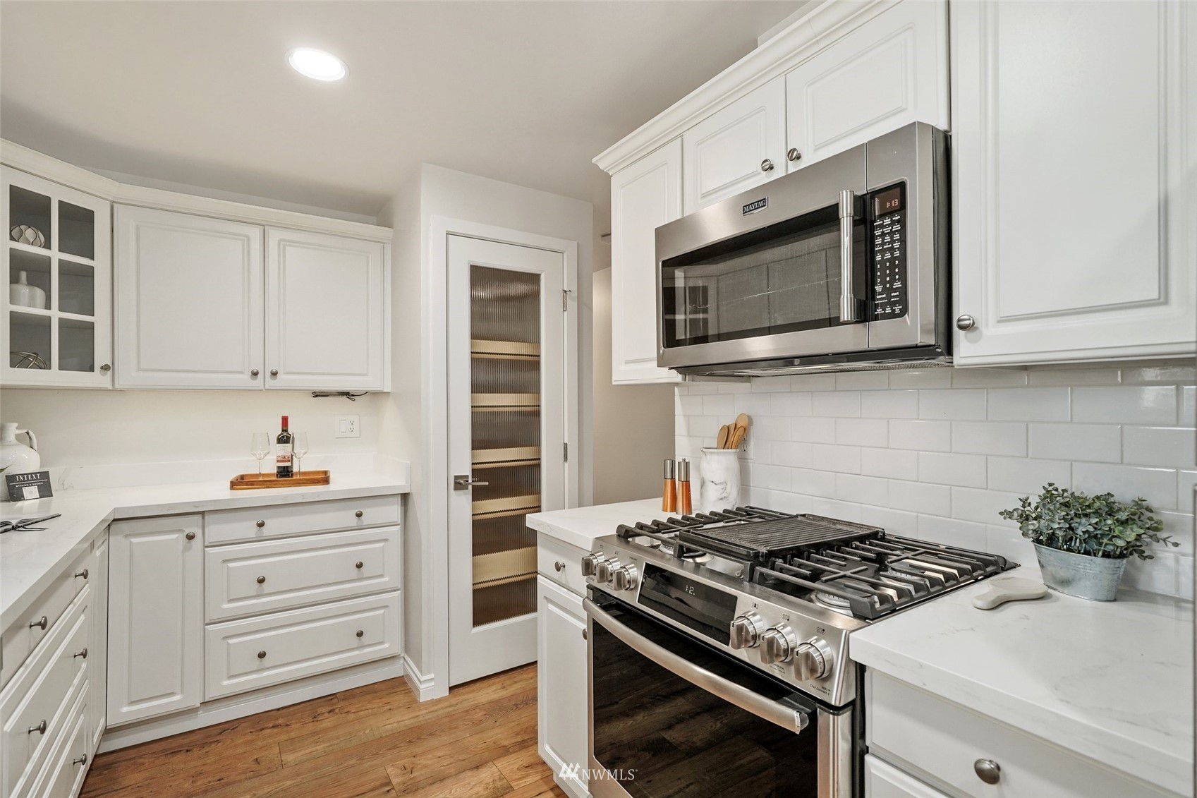 3007 Stafford Way Bothell, WA 98012 - Photo 14 of 32 a kitchen with stainless steel appliances a stove a microwave and cabinets