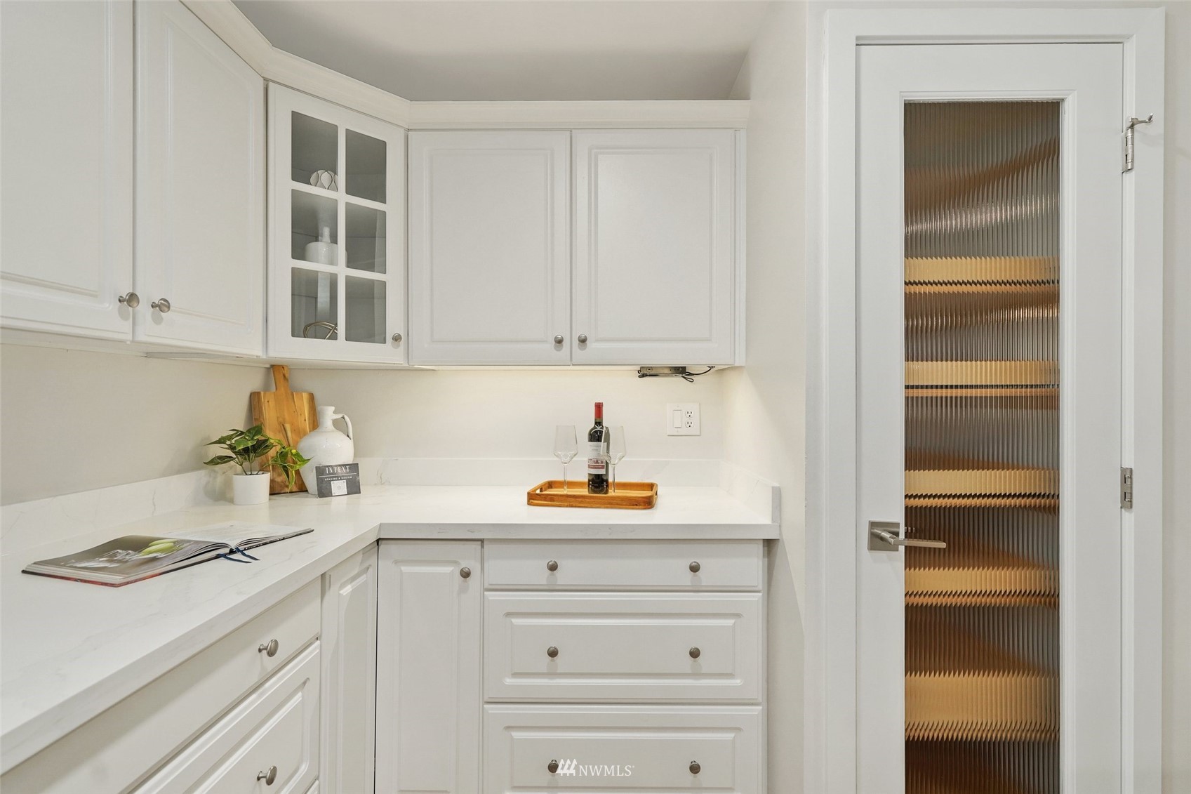 3007 Stafford Way Bothell, WA 98012 - Photo 16 of 32 a kitchen with a refrigerator and white cabinets