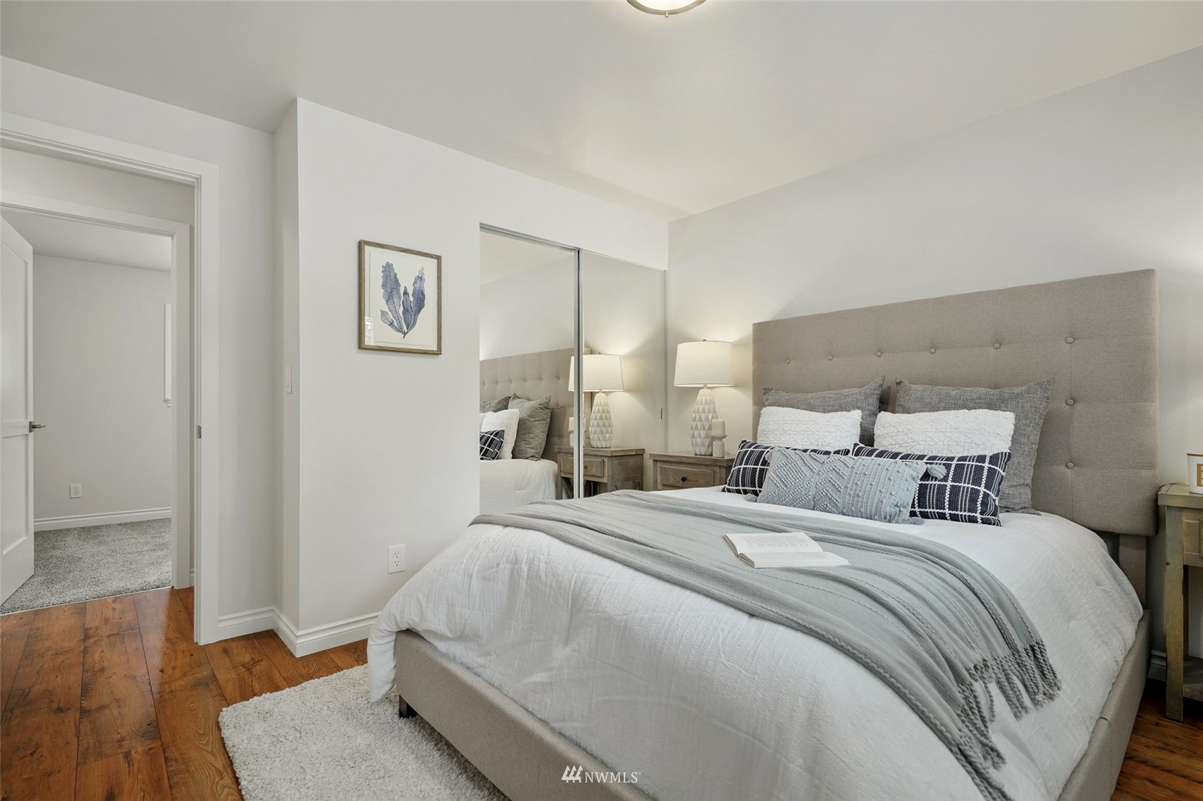 3007 Stafford Way Bothell, WA 98012 - Photo 20 of 32 a bedroom with a bed and wooden floor