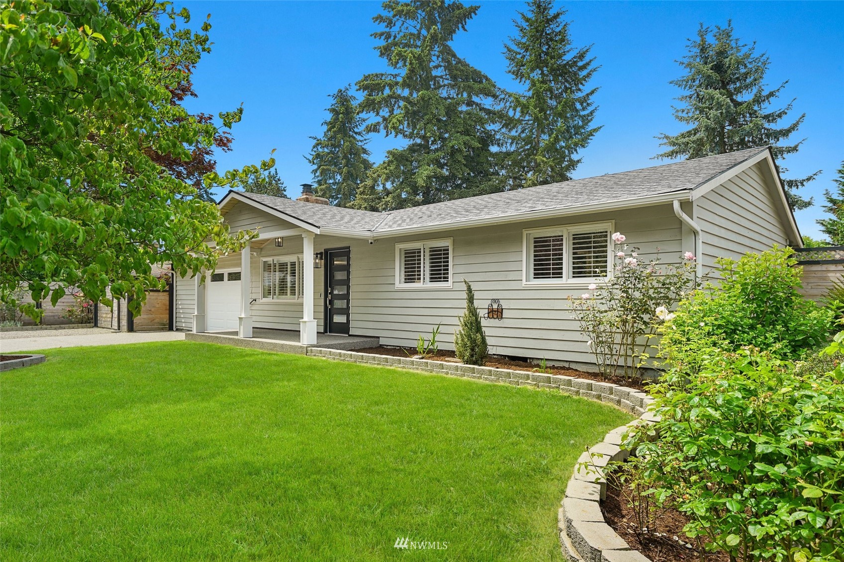 3007 Stafford Way Bothell, WA 98012 - Photo 2 of 32 a front view of a house with a garden