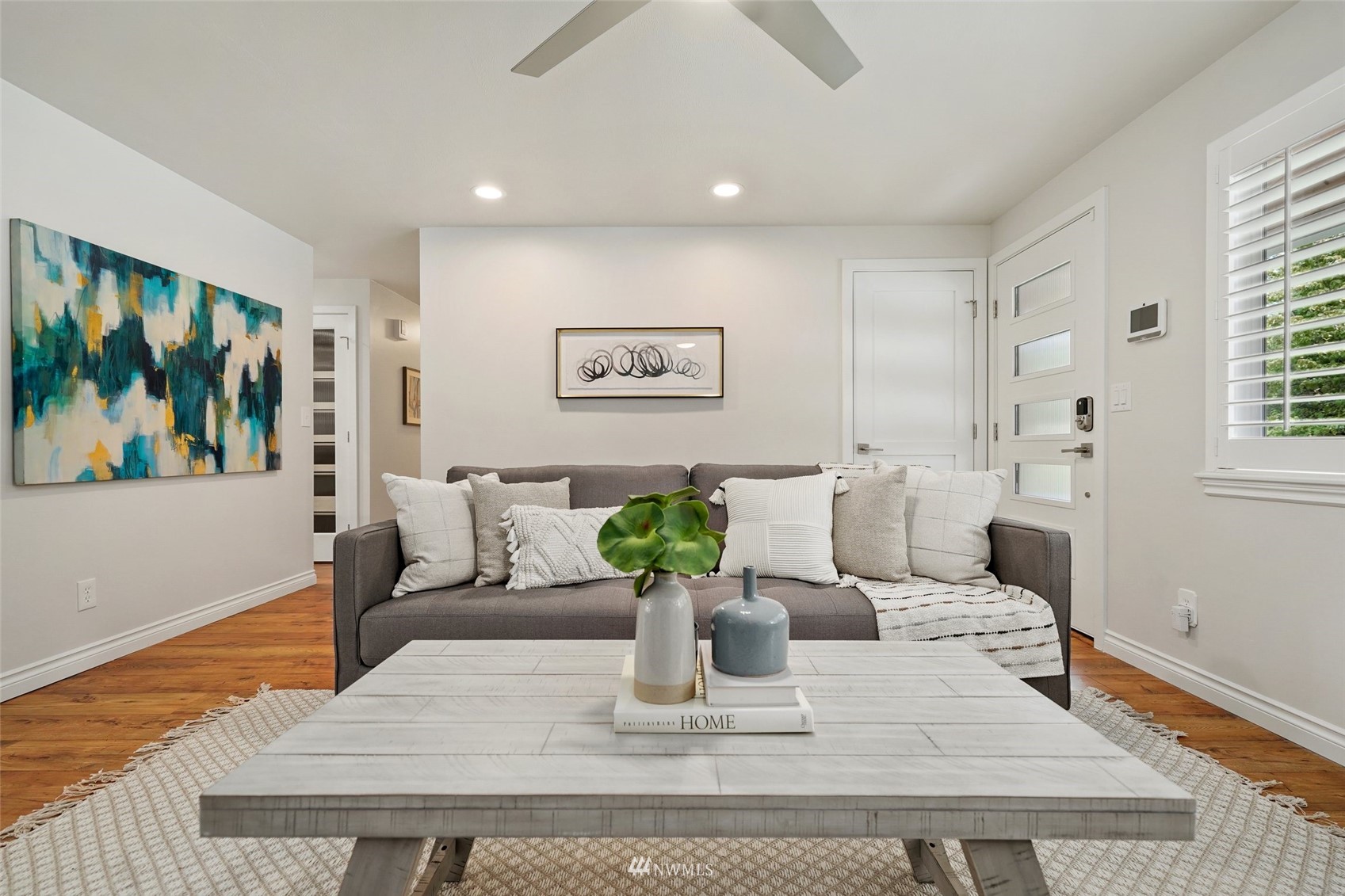 3007 Stafford Way Bothell, WA 98012 - Photo 7 of 32 a view of a dining room with furniture a painting and wooden floor