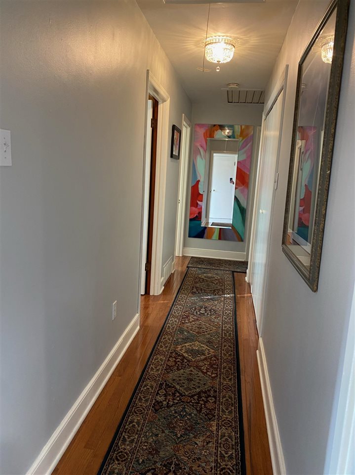 322 McElroy Road Memphis, TN 38120 - Photo 11 of 16 a hallway with painting on the wall and a large mirror