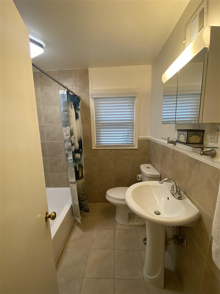 322 McElroy Road Memphis, TN 38120 - Photo 13 of 16 a bathroom with a sink a toilet and a mirror
